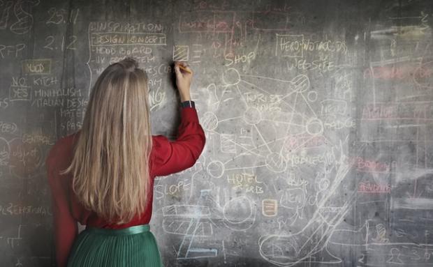 intelligenza woman in red long sleeve writing on chalk board 3769714